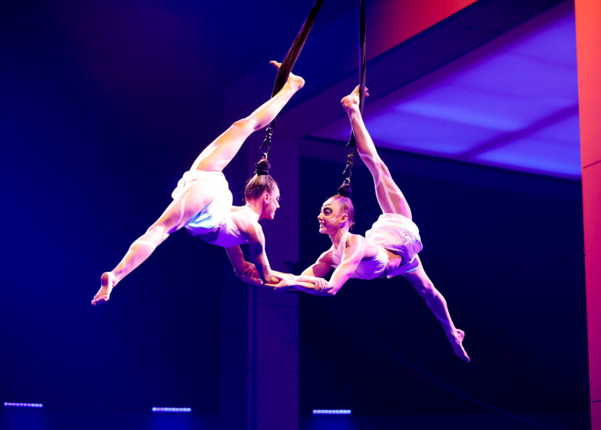 Corte Cirque du Soleil Aerial dancers perform at an event for women's empowerment and personal growth, symbolizing professional and personal development.